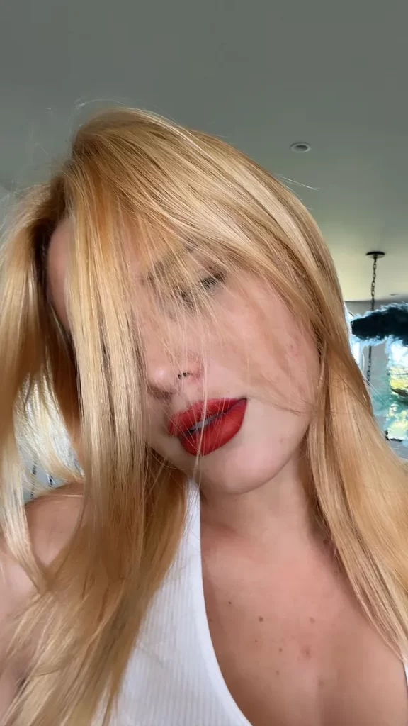 Bella Thorne shows off her model physique in a white sports bra 